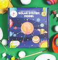 Child painting planet foam ball close up