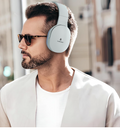 Light-coloured Vismac over-ear wireless headphones with padded headband and ear cups