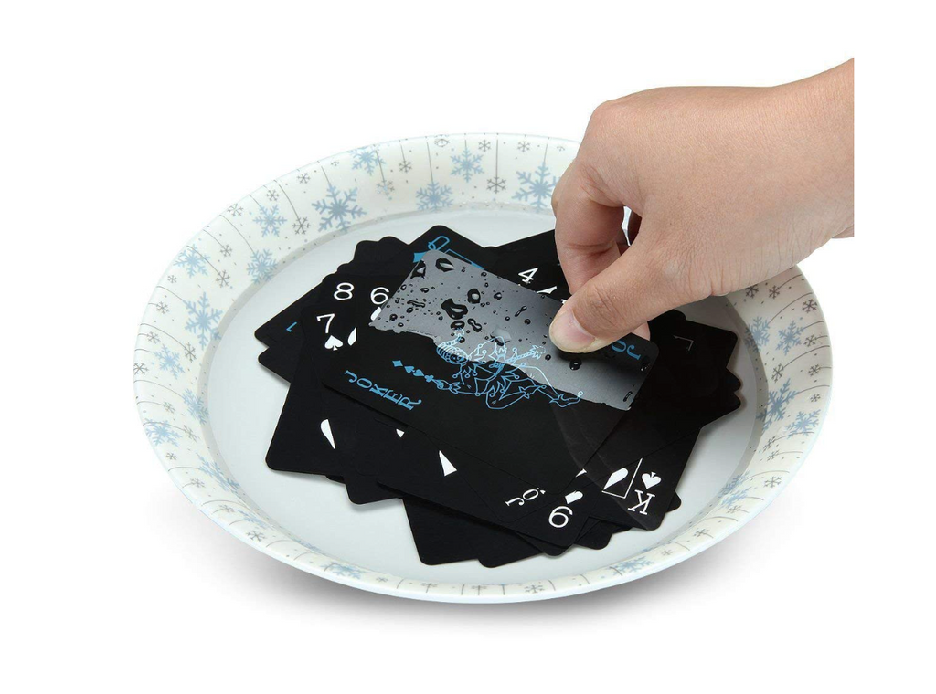 Black playing-card box with blue king illustration on newspaper backdrop