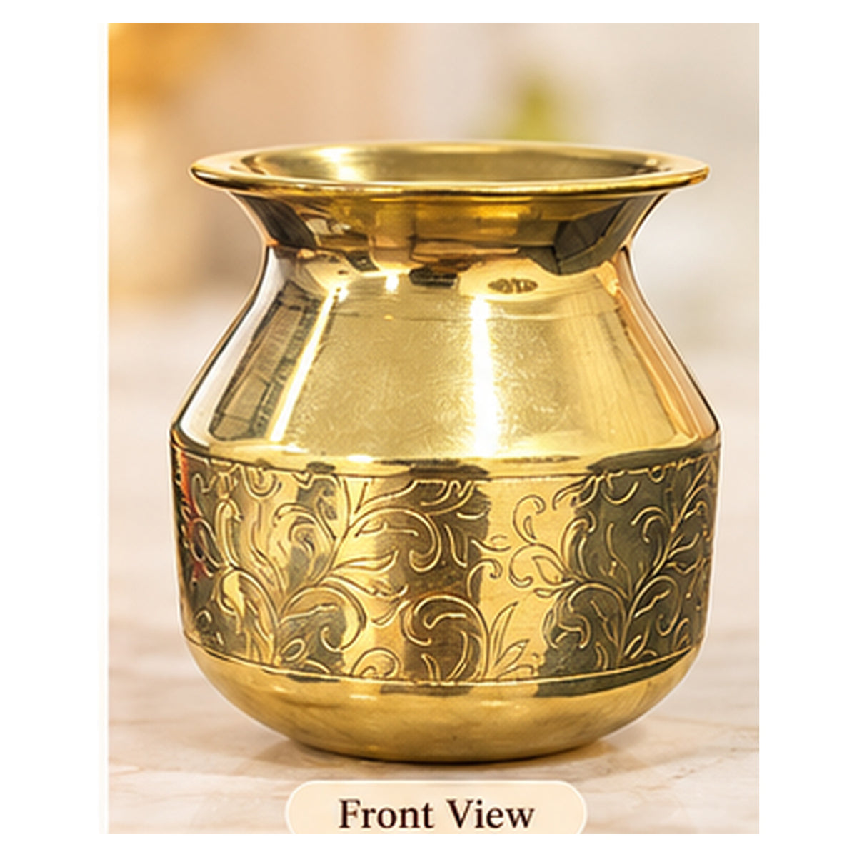 Engraved golden pooja lota showing floral decoration