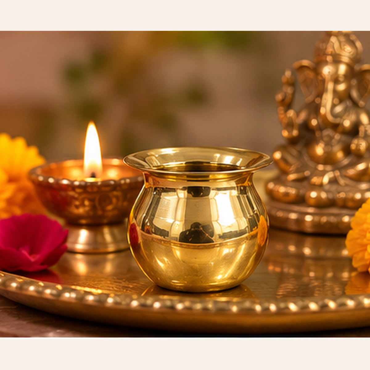 Small golden lota on puja thali, other props excluded