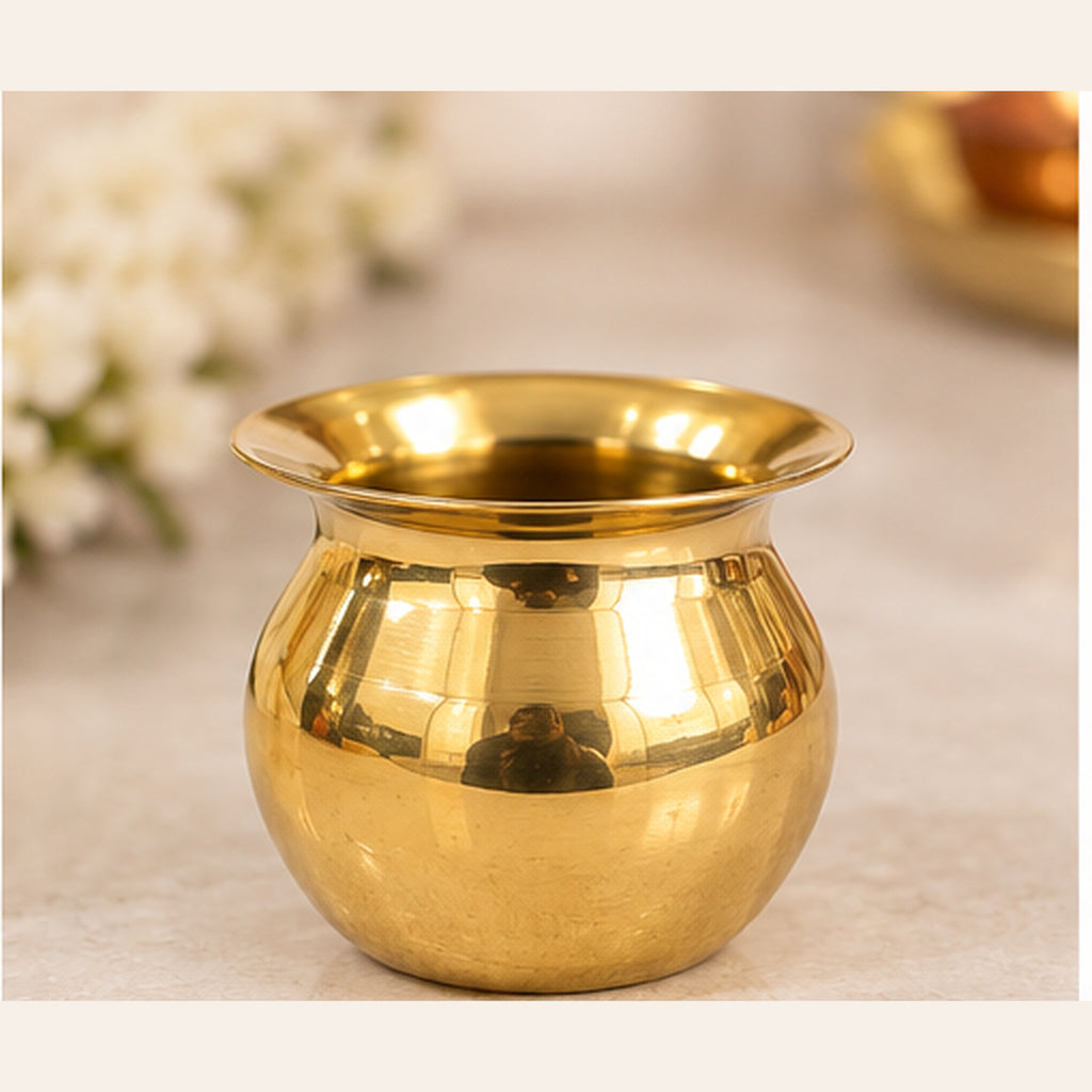 Mini golden pooja lota on studio background