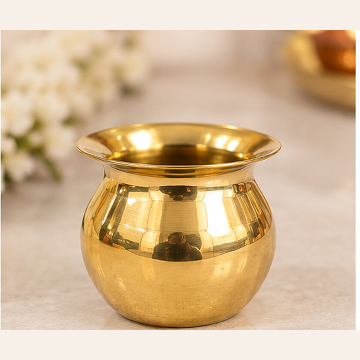 Mini golden pooja lota on studio background