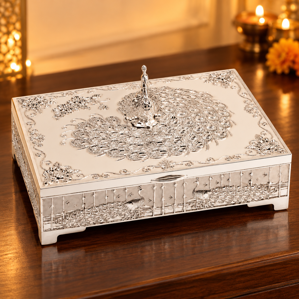 Styled festive view of silver-tone peacock dry fruit box