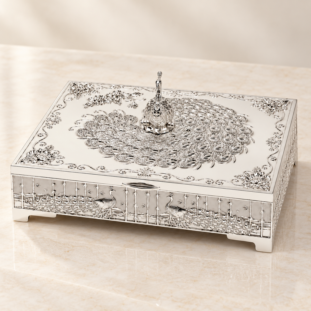 Styled studio view of silver-tone peacock dry fruit box