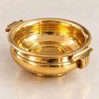 AI-styled plain gold-tone urli — Rim and handle detail
